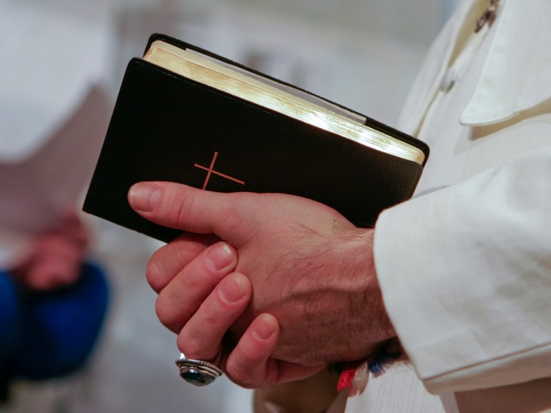 Man in popes garment holding holy bible. Adobe RGB for better color reproduction.Photo: iStock