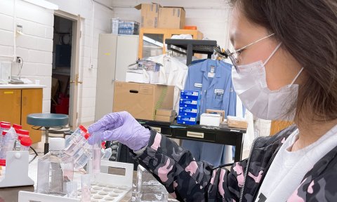 Photo of a female scientist working in a lab at NIIMBL.
