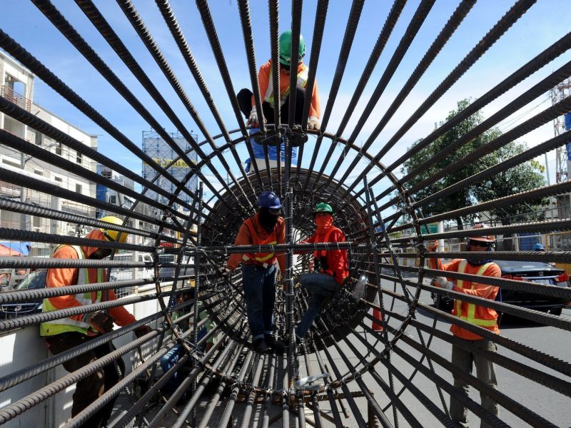 Construction workers prepare to put up a column for an elevated highway project in Manila on November 4, 2015. The government is rushing the construction of toll roads to solve a worsening traffic situation.   AFP PHOTO / Jay DIRECTO / AFP PHOTO / JAY DIRECTO